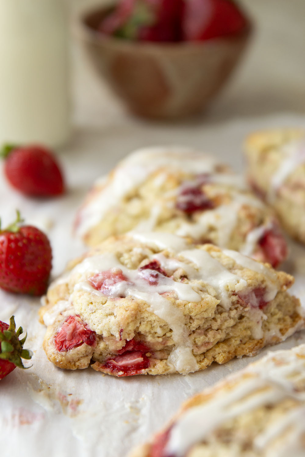 Loaded with little bursts of fresh strawberries and drizzled with a rich sweet cream glaze, these flaky strawberries and cream scones are always the most popular pastry on the table!