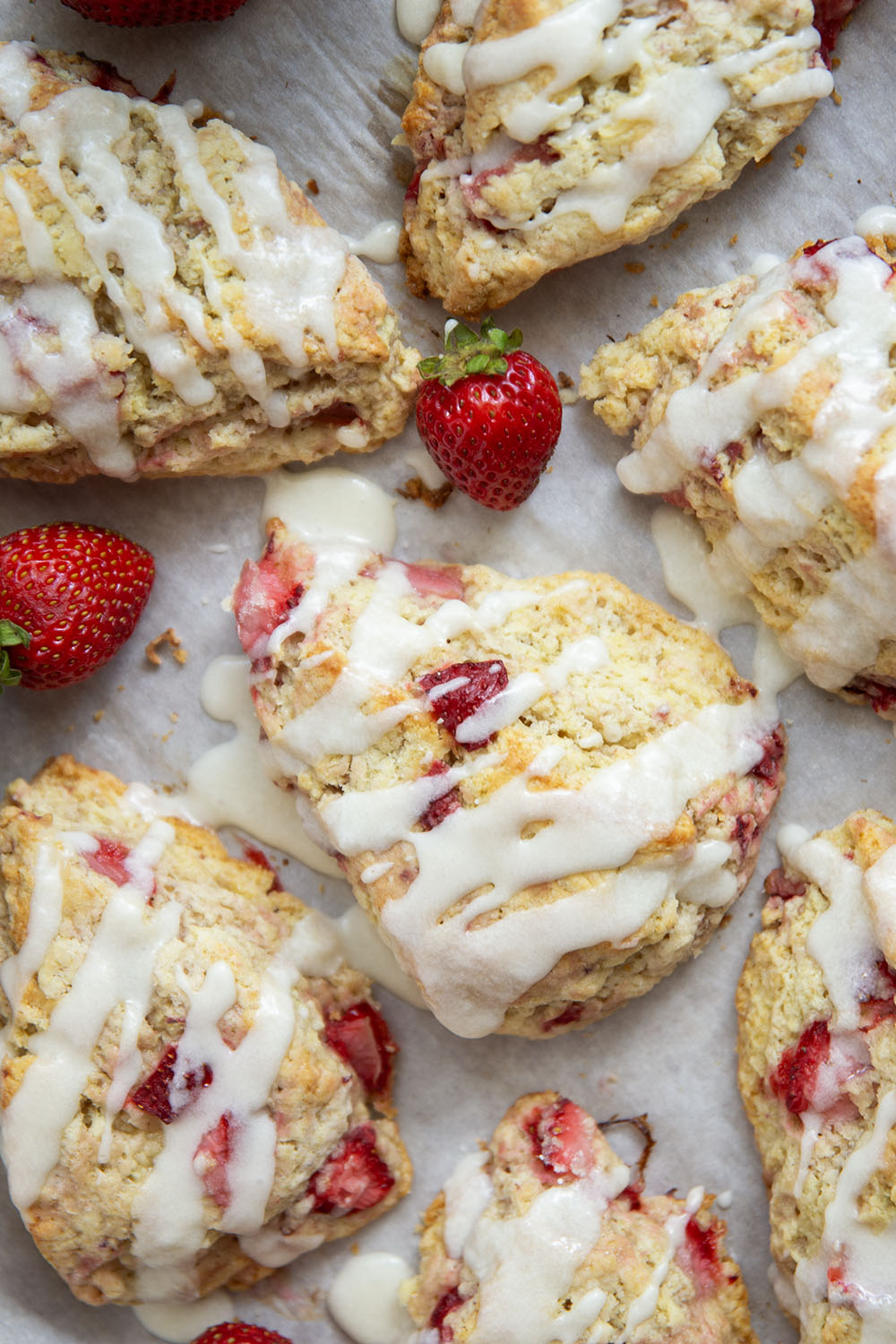 Loaded with little bursts of fresh strawberries and drizzled with a rich sweet cream glaze, these flaky strawberries and cream scones are always the most popular pastry on the table!