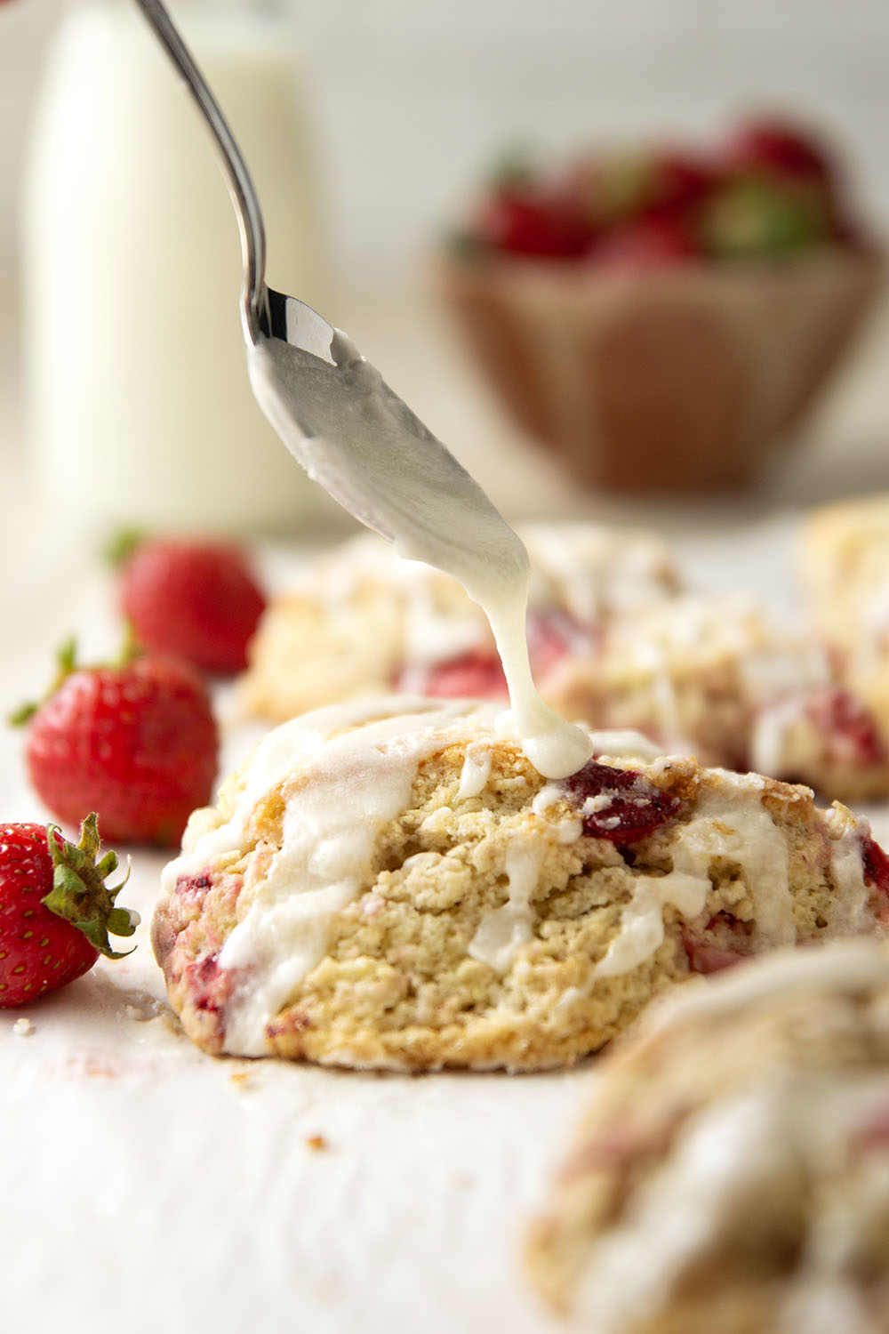Loaded with little bursts of fresh strawberries and drizzled with a rich sweet cream glaze, these flaky strawberries and cream scones are always the most popular pastry on the table!