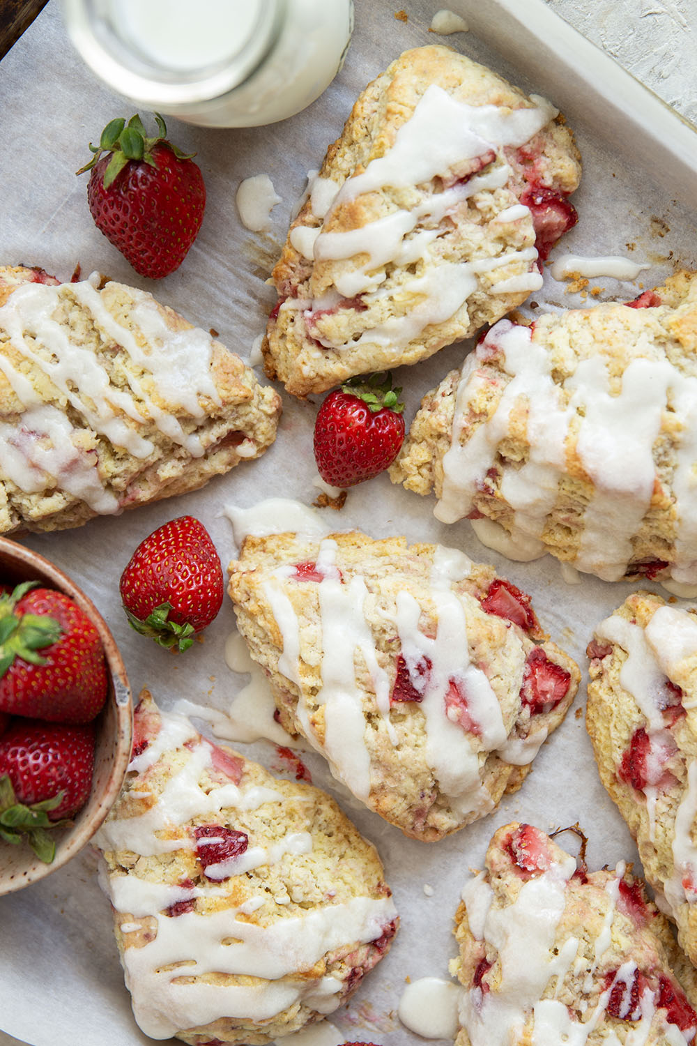 Loaded with little bursts of fresh strawberries and drizzled with a rich sweet cream glaze, these flaky strawberries and cream scones are always the most popular pastry on the table!
