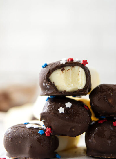 These vanilla pudding popsicles feature creamy homemade vanilla pudding frozen into pops and dipped in chocolate. Keep these stocked in your freezer all summer!