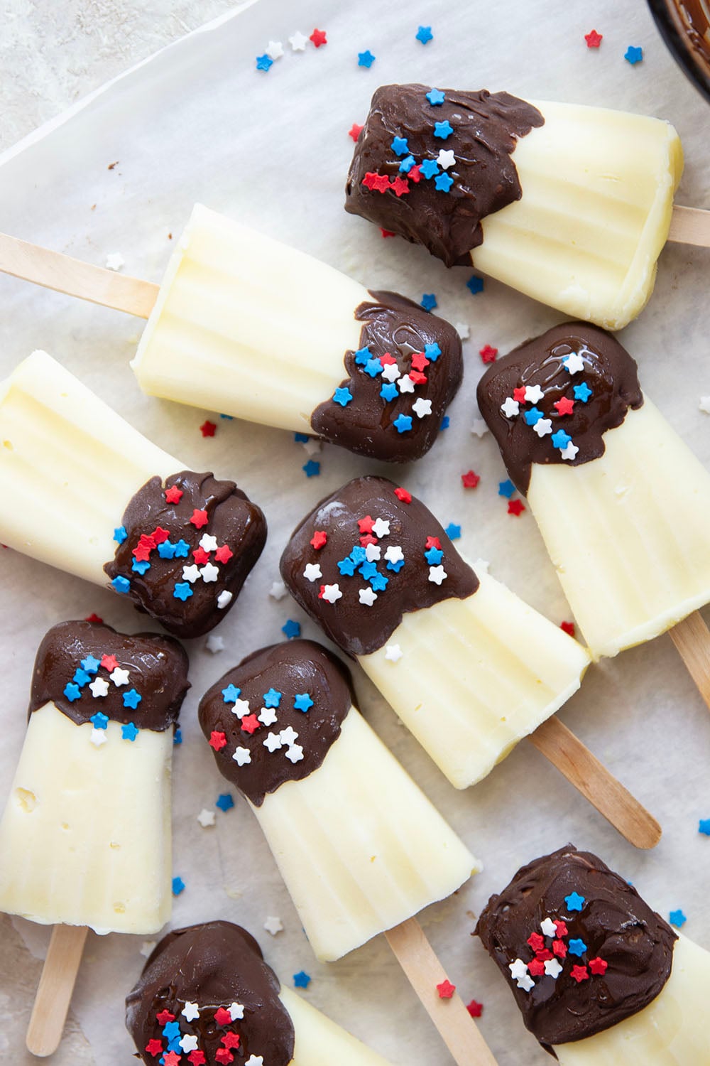 These vanilla pudding popsicles feature creamy homemade vanilla pudding frozen into pops and dipped in chocolate. Keep these stocked in your freezer all summer!