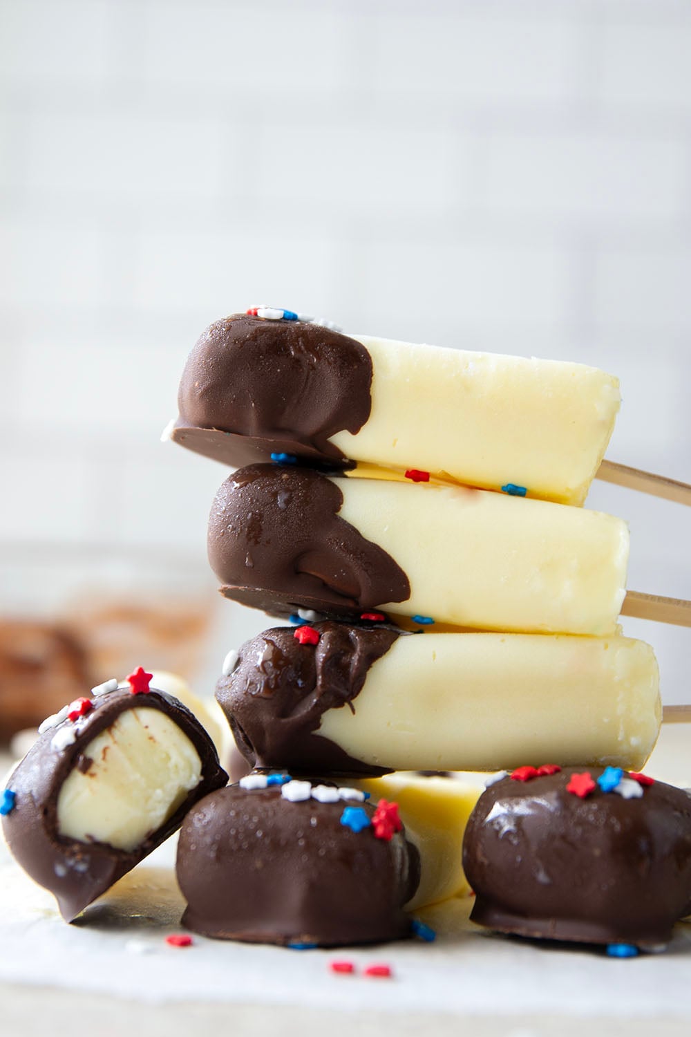 These vanilla pudding popsicles feature creamy homemade vanilla pudding frozen into pops and dipped in chocolate. Keep these stocked in your freezer all summer!
