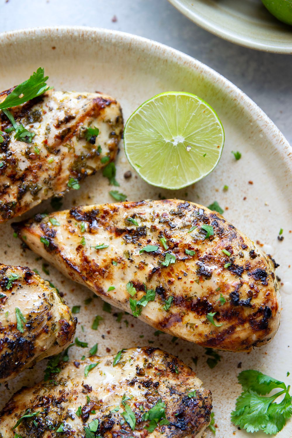 Marinated for hours in a flavorful fresh lime and cilantro marinade and then thrown on the grill, this grilled cilantro lime chicken is impossibly juicy and will quickly become a grill staple!