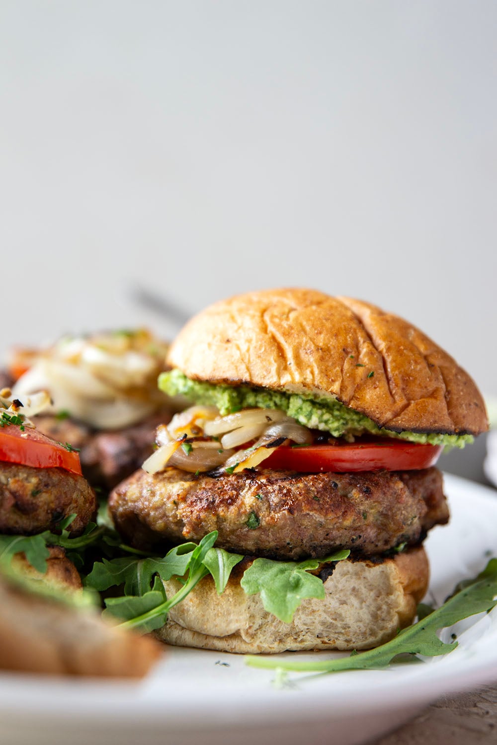 These feta turkey burgers have the ultimate juicy texture! A silky spinach whipped feta and plenty of grilled onions take them over the top.