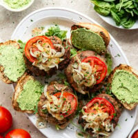 These feta turkey burgers have the ultimate juicy texture! A silky spinach whipped feta and plenty of grilled onions take them over the top.