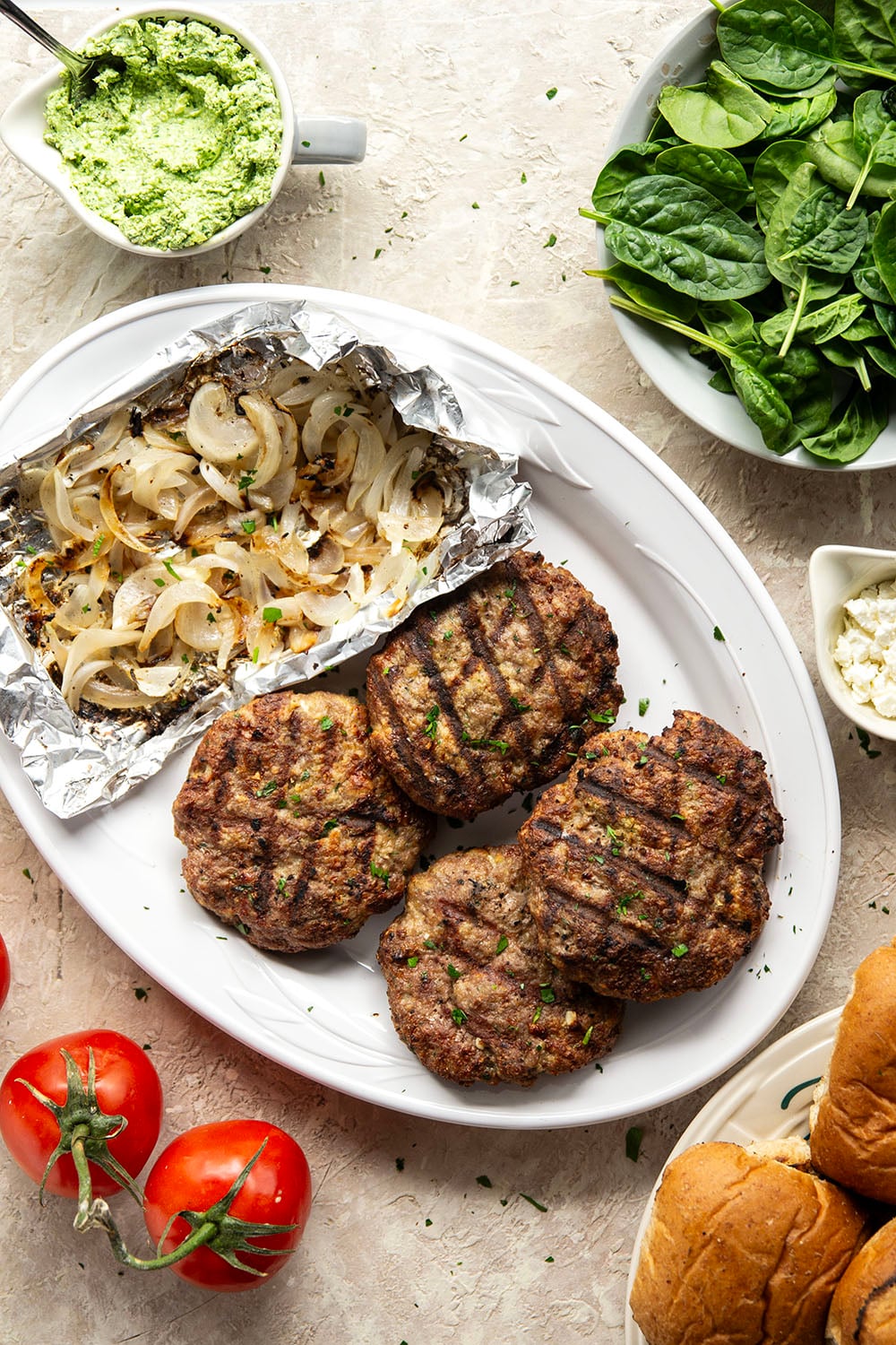 These feta turkey burgers have the ultimate juicy texture! A silky spinach whipped feta and plenty of grilled onions take them over the top.