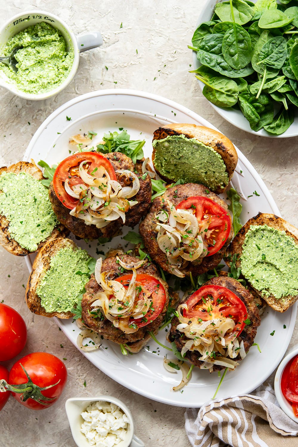 These feta turkey burgers have the ultimate juicy texture! A silky spinach whipped feta and plenty of grilled onions take them over the top.