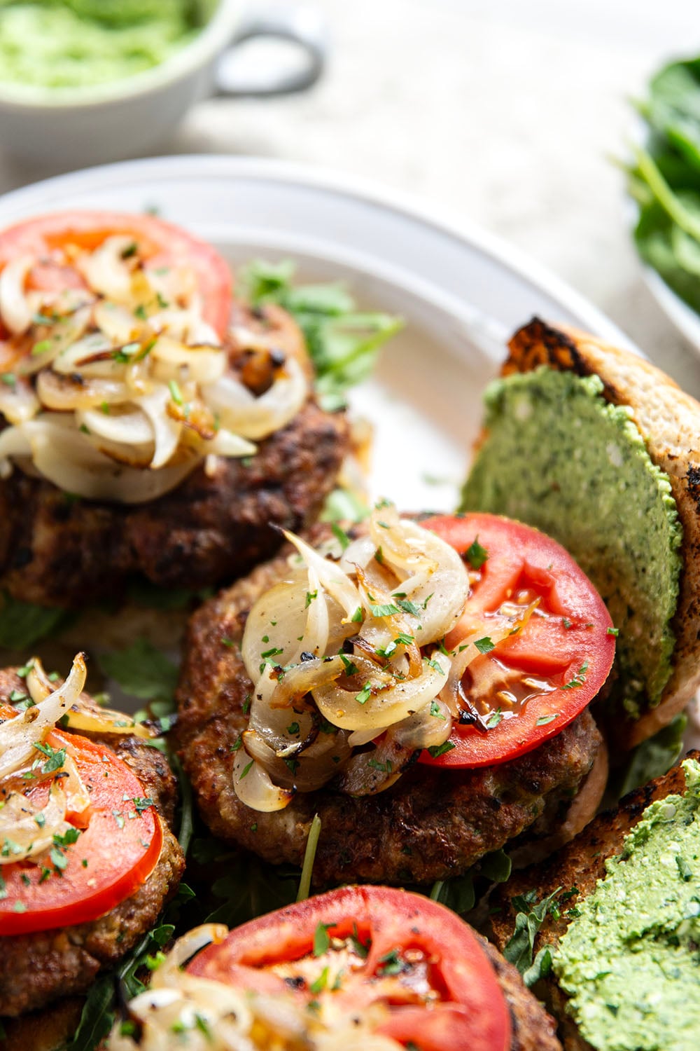 These feta turkey burgers have the ultimate juicy texture! A silky spinach whipped feta and plenty of grilled onions take them over the top.