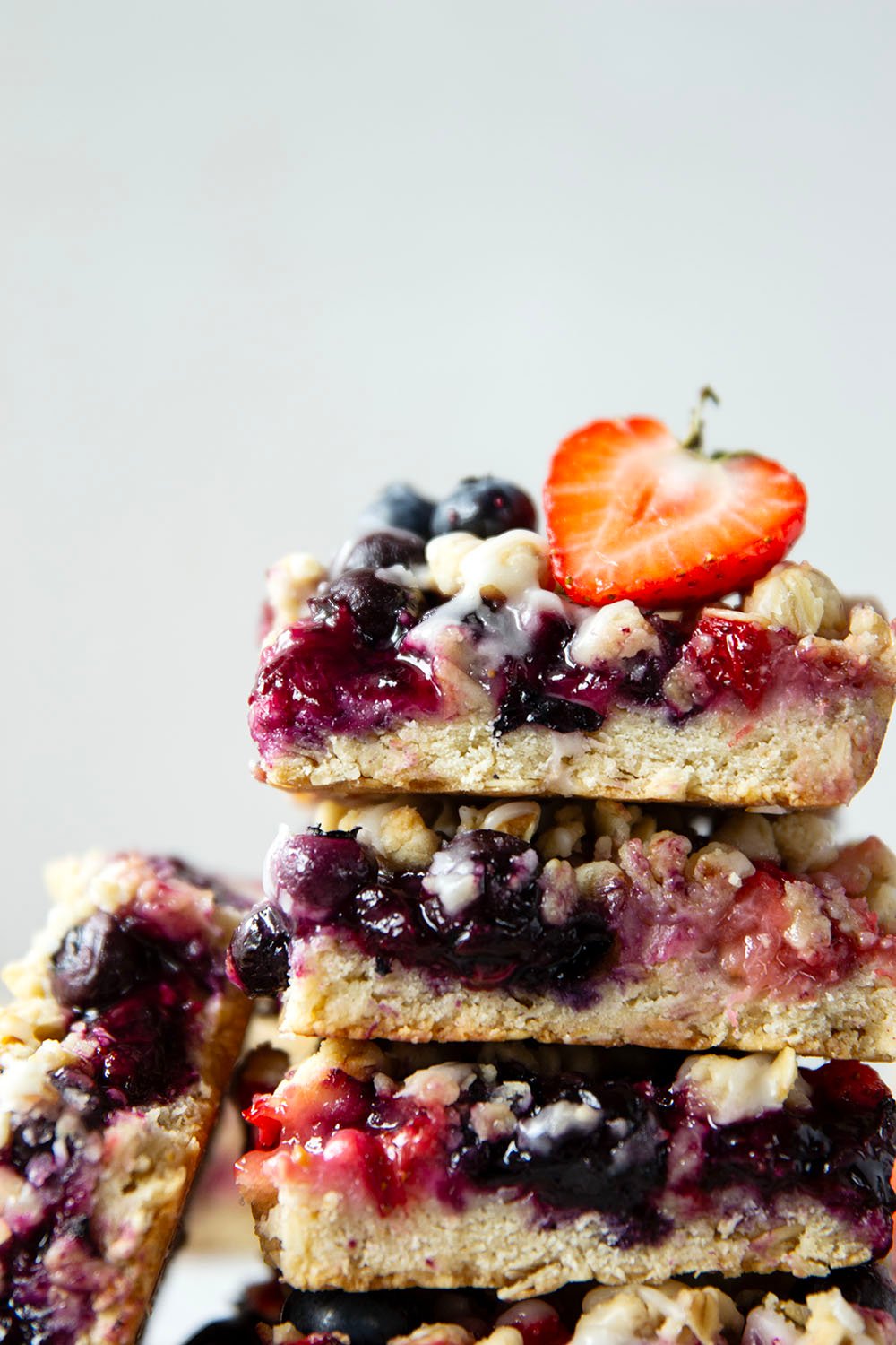 Loaded with a double whammy of berries, lots of streusel, and a creamy vanilla glaze, these red white and blue bars are an easy, festive treat for the 4th of July!