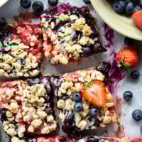 Loaded with a double whammy of berries, lots of streusel, and a creamy vanilla glaze, these red white and blue bars are an easy, festive treat for the 4th of July!