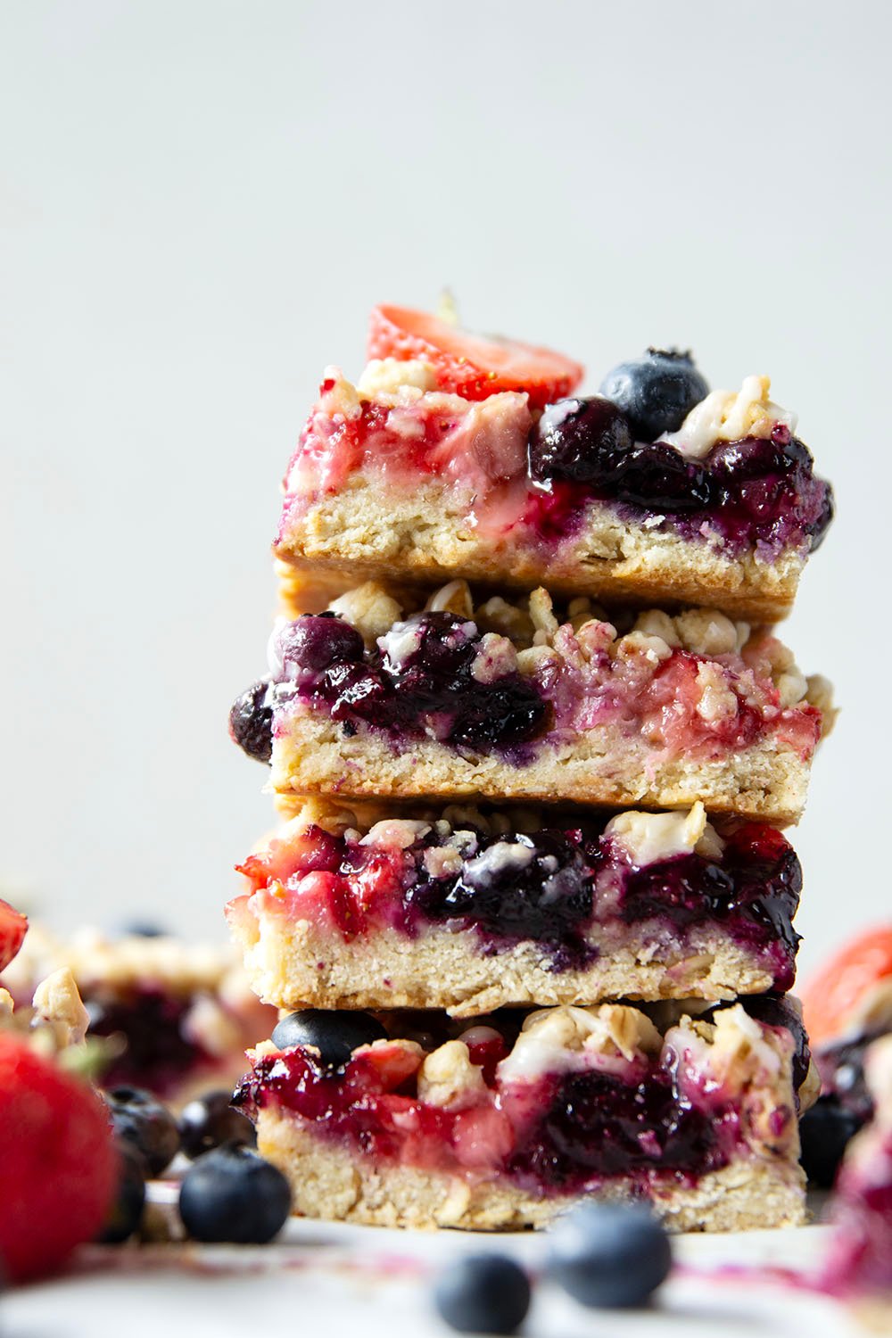 Loaded with a double whammy of berries, lots of streusel, and a creamy vanilla glaze, these red white and blue bars are an easy, festive treat for the 4th of July!