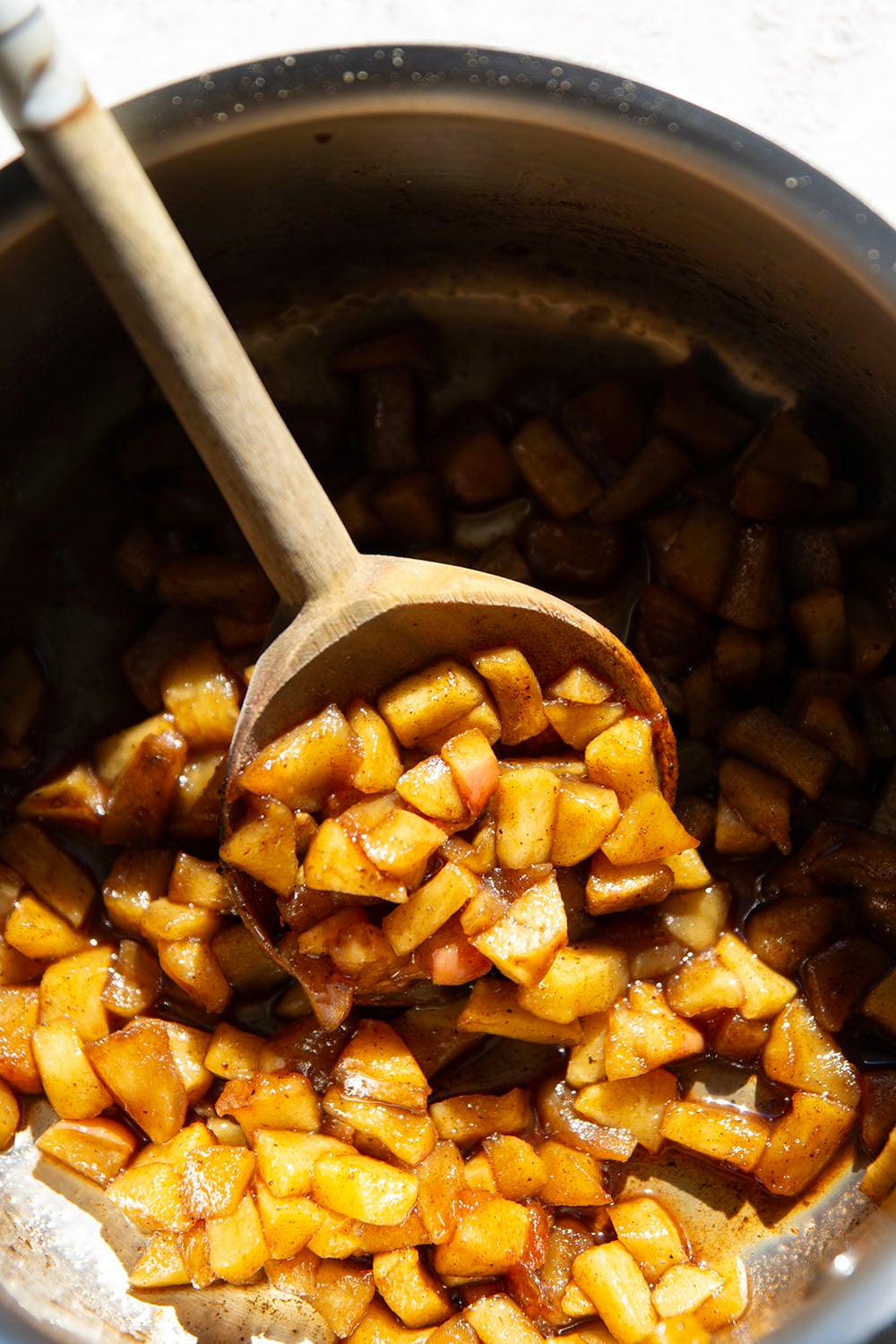 These caramel apple pie cookies feature a soft and chewy butter cookie base with a caramelized apple center, rich drizzles of caramel sauce, and crushed cinnamon crunch cereal on top.