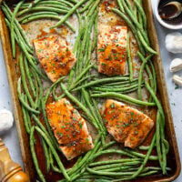 Sweet and sticky honey garlic salmon is baked on one sheet pan alongside tender green beans for a mess-free, flavor-packed weeknight dinner!