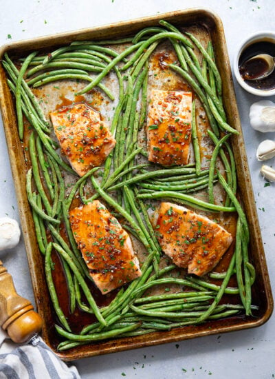 Sweet and sticky honey garlic salmon is baked on one sheet pan alongside tender green beans for a mess-free, flavor-packed weeknight dinner!