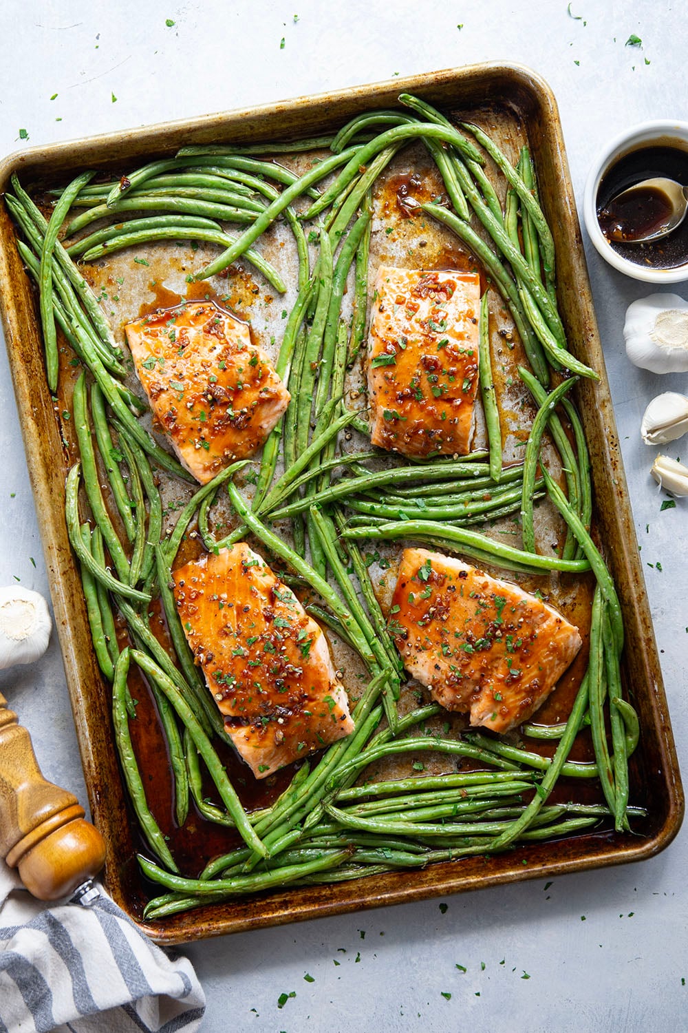 Sweet and sticky honey garlic salmon is baked on one sheet pan alongside tender green beans for a mess-free, flavor-packed weeknight dinner!