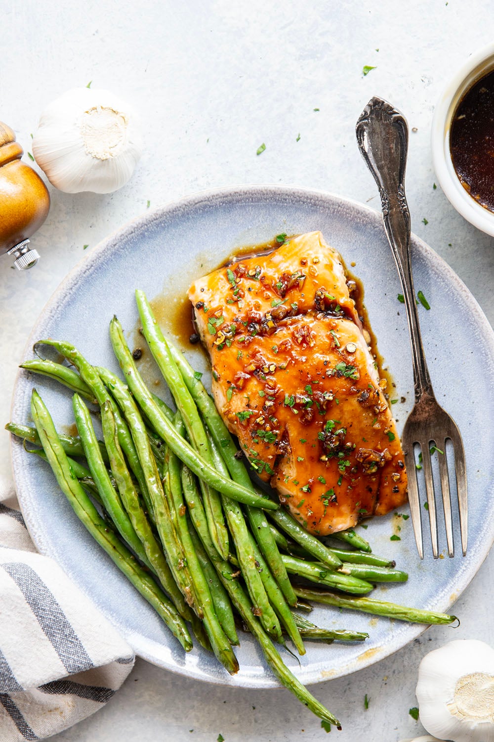 Sweet and sticky honey garlic salmon is baked on one sheet pan alongside tender green beans for a mess-free, flavor-packed weeknight dinner!