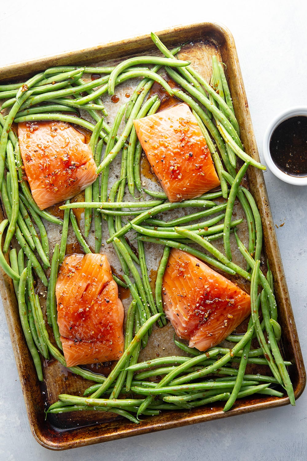 Sweet and sticky honey garlic salmon is baked on one sheet pan alongside tender green beans for a mess-free, flavor-packed weeknight dinner!