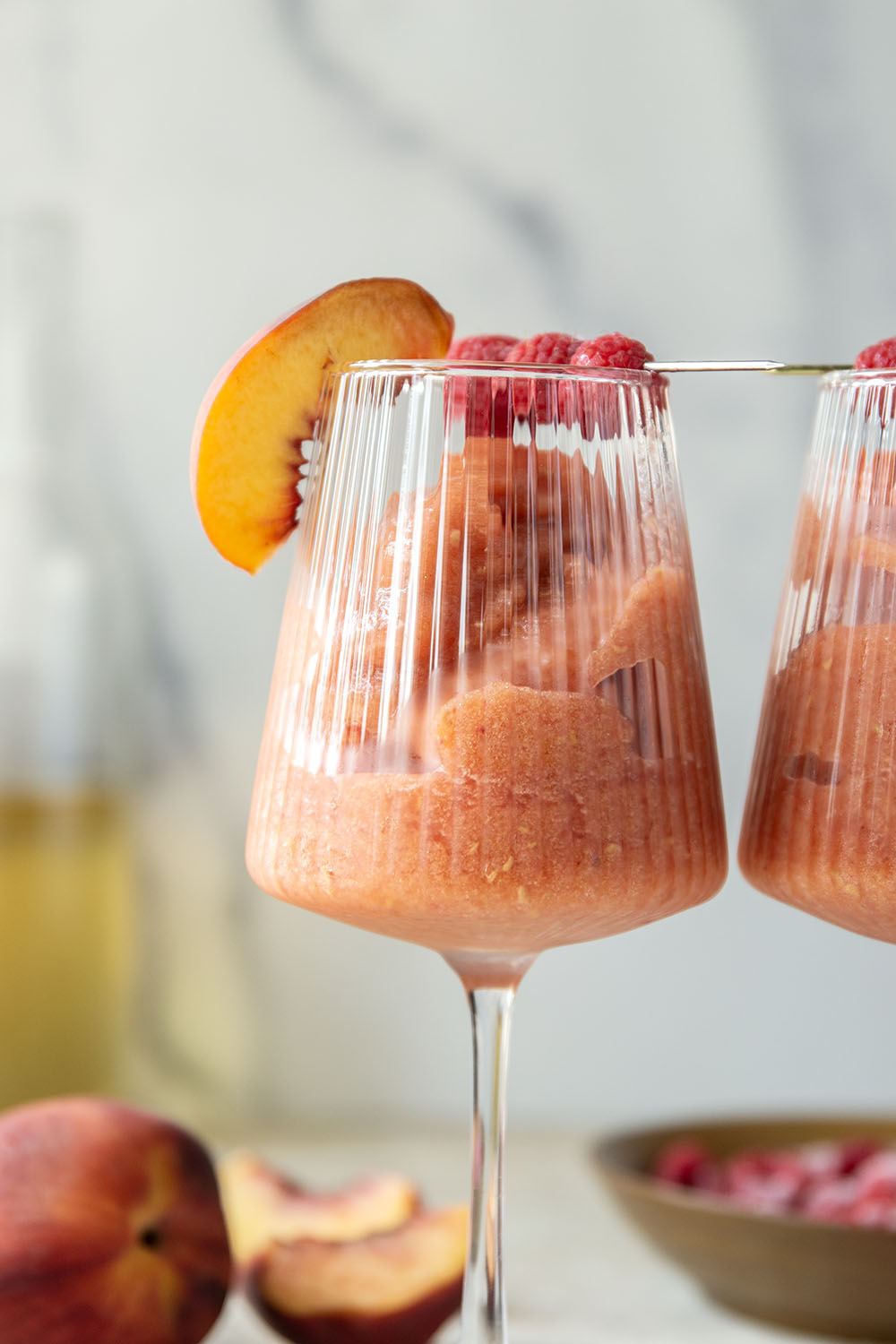These peach raspberry wine slushies are exploding with sweet summer peaches and raspberries. They blend up in minutes and you can easily double the recipe for a crowd.