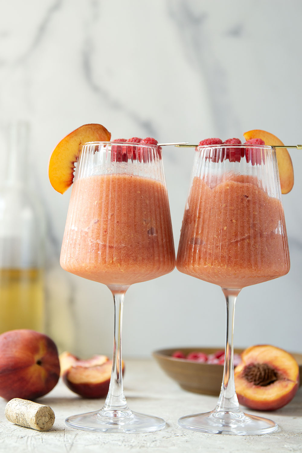These peach raspberry wine slushies are exploding with sweet summer peaches and raspberries. They blend up in minutes and you can easily double the recipe for a crowd.