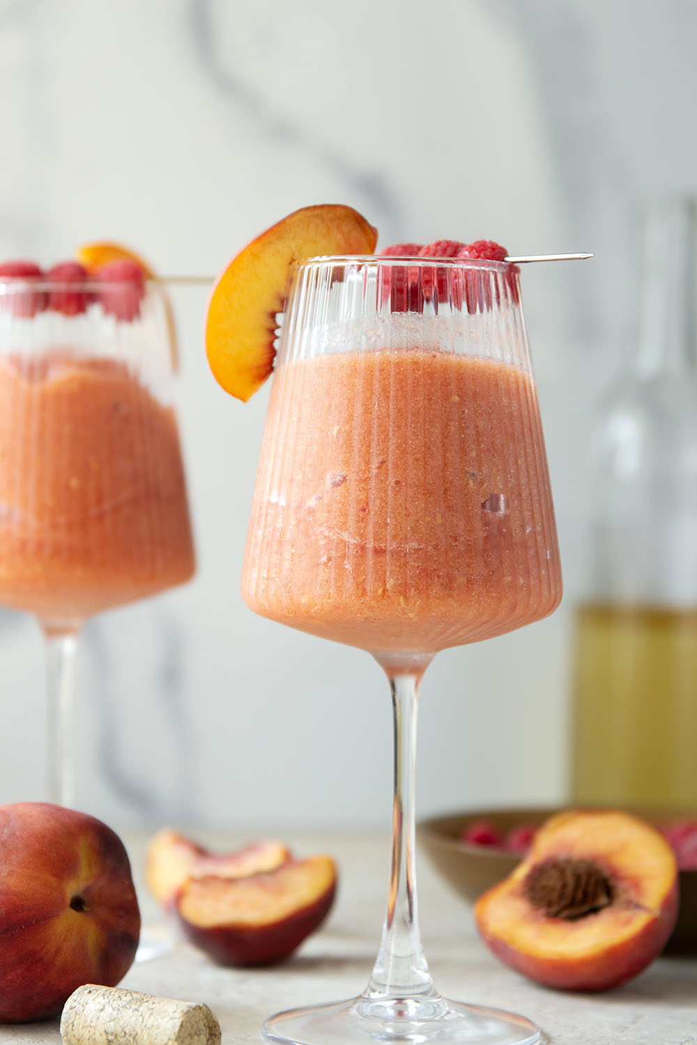 These peach raspberry wine slushies are exploding with sweet summer peaches and raspberries. They blend up in minutes and you can easily double the recipe for a crowd.