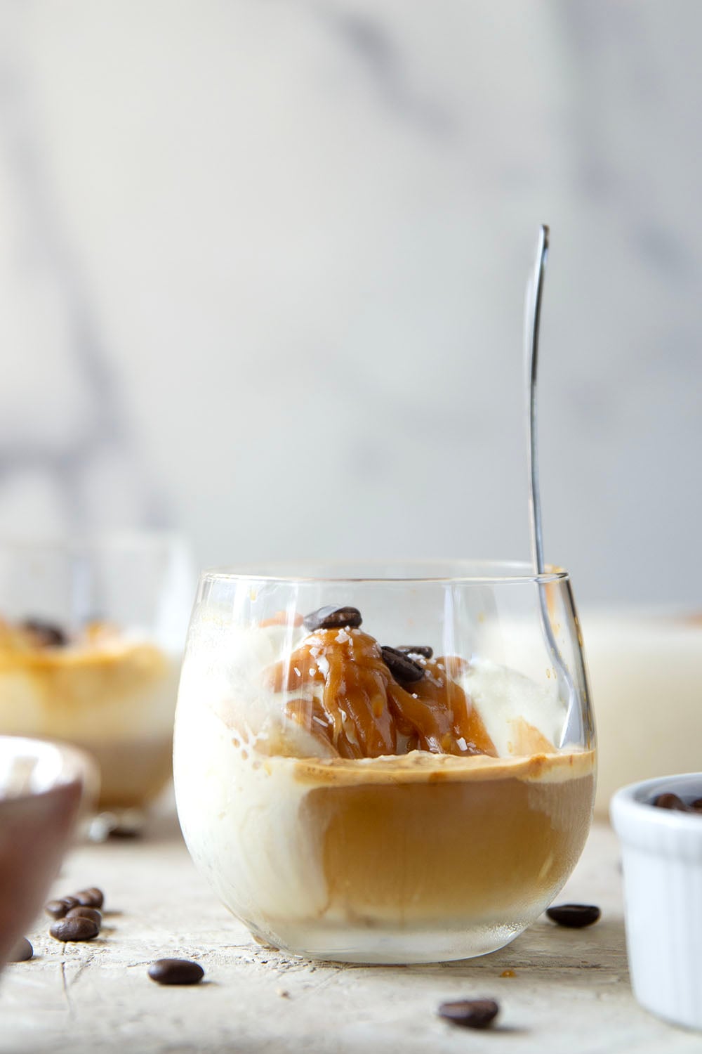 Drizzles of homemade salted caramel sauce, rich espresso, and creamy vanilla ice cream come together in this salted caramel affogato.