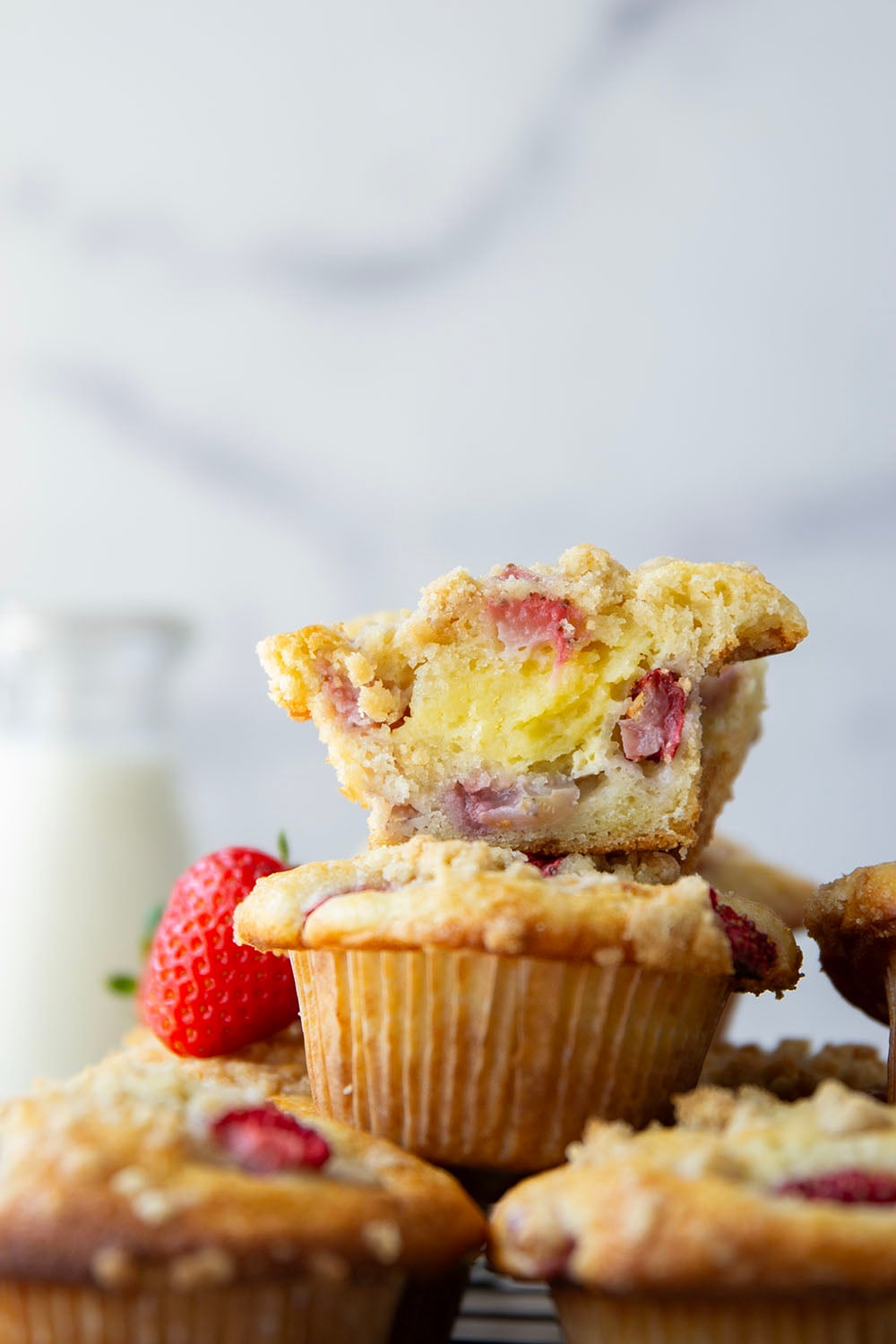 Packed with juicy strawberries, filled with a luscious cheesecake filling, and topped with a buttery crumb topping, these strawberry cheesecake muffins are the best of all worlds wrapped up into one muffin.