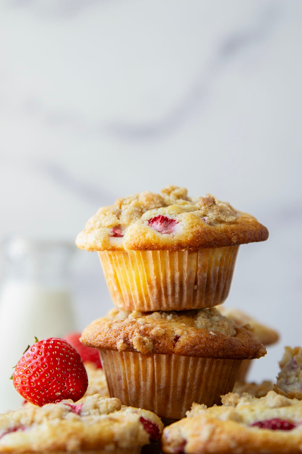 Packed with juicy strawberries, filled with a luscious cheesecake filling, and topped with a buttery crumb topping, these strawberry cheesecake muffins are the best of all worlds wrapped up into one muffin.