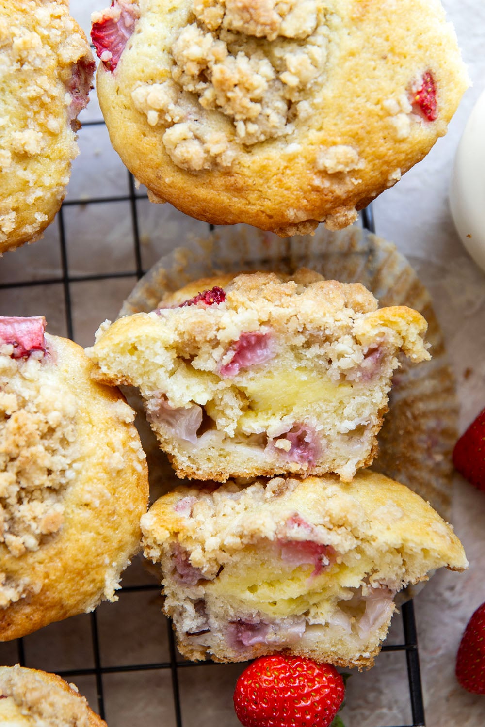 Packed with juicy strawberries, filled with a luscious cheesecake filling, and topped with a buttery crumb topping, these strawberry cheesecake muffins are the best of all worlds wrapped up into one muffin.