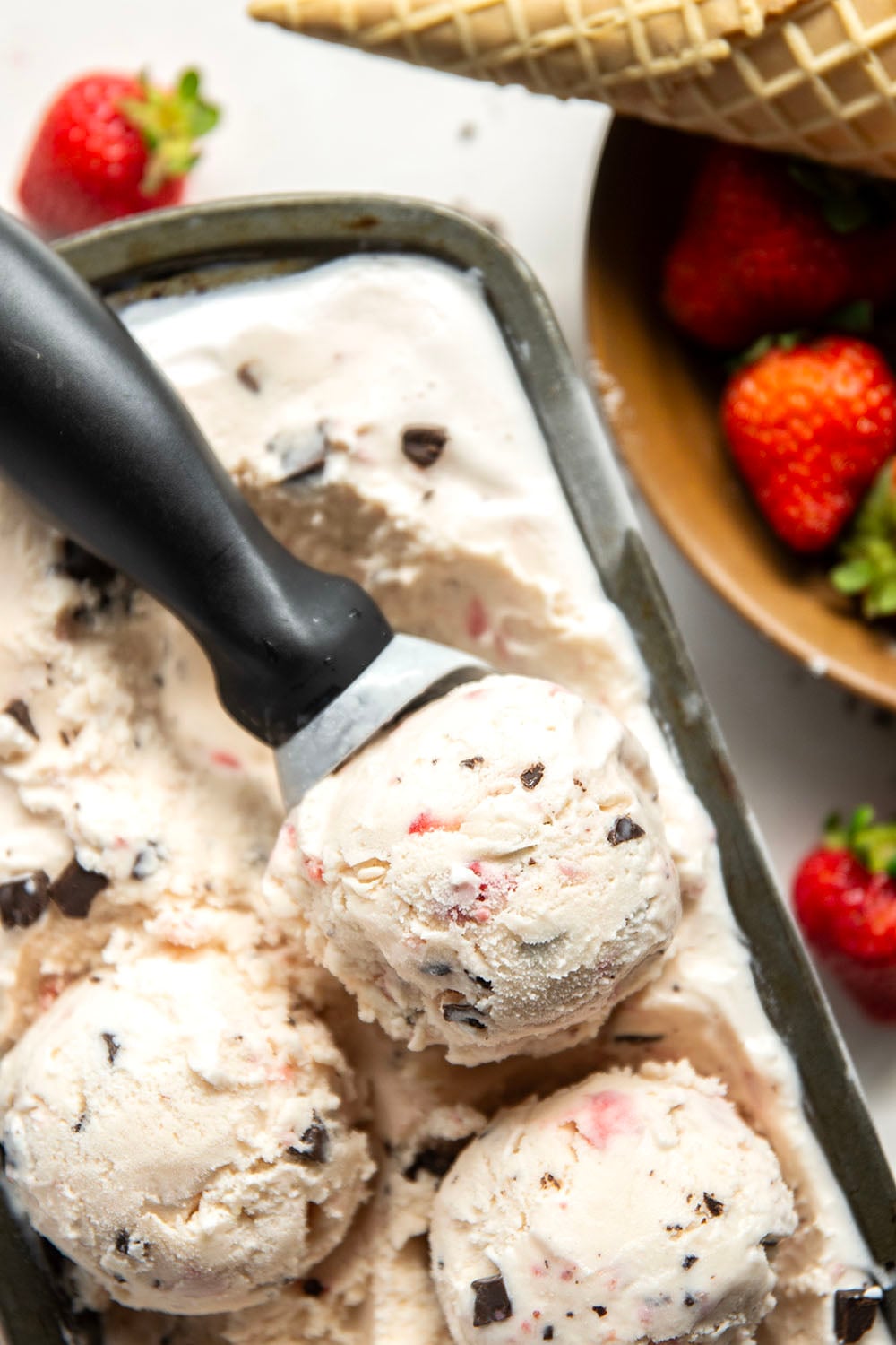 Churned with a fresh strawberry sauce and lots of chocolate chip pieces, this strawberry chocolate chip ice cream is dreamy with fresh summer strawberries!
