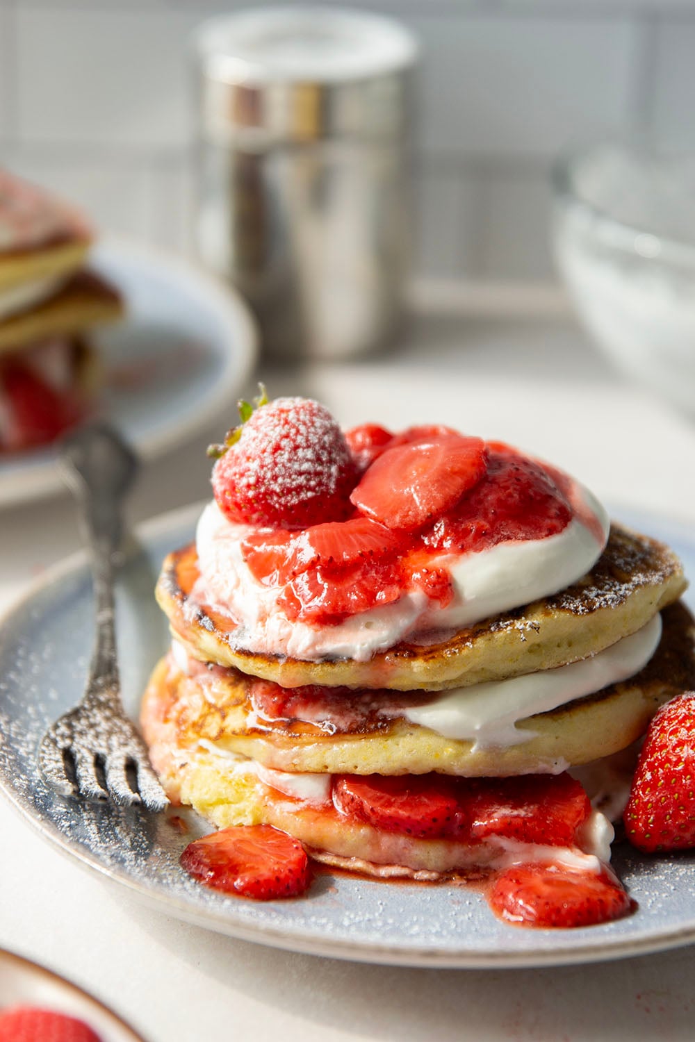 These strawberry shortcake pancakes feature layers of fluffy buttermilk cornmeal pancakes, fresh whipped cream, and lots of juicy fresh strawberry sauce.