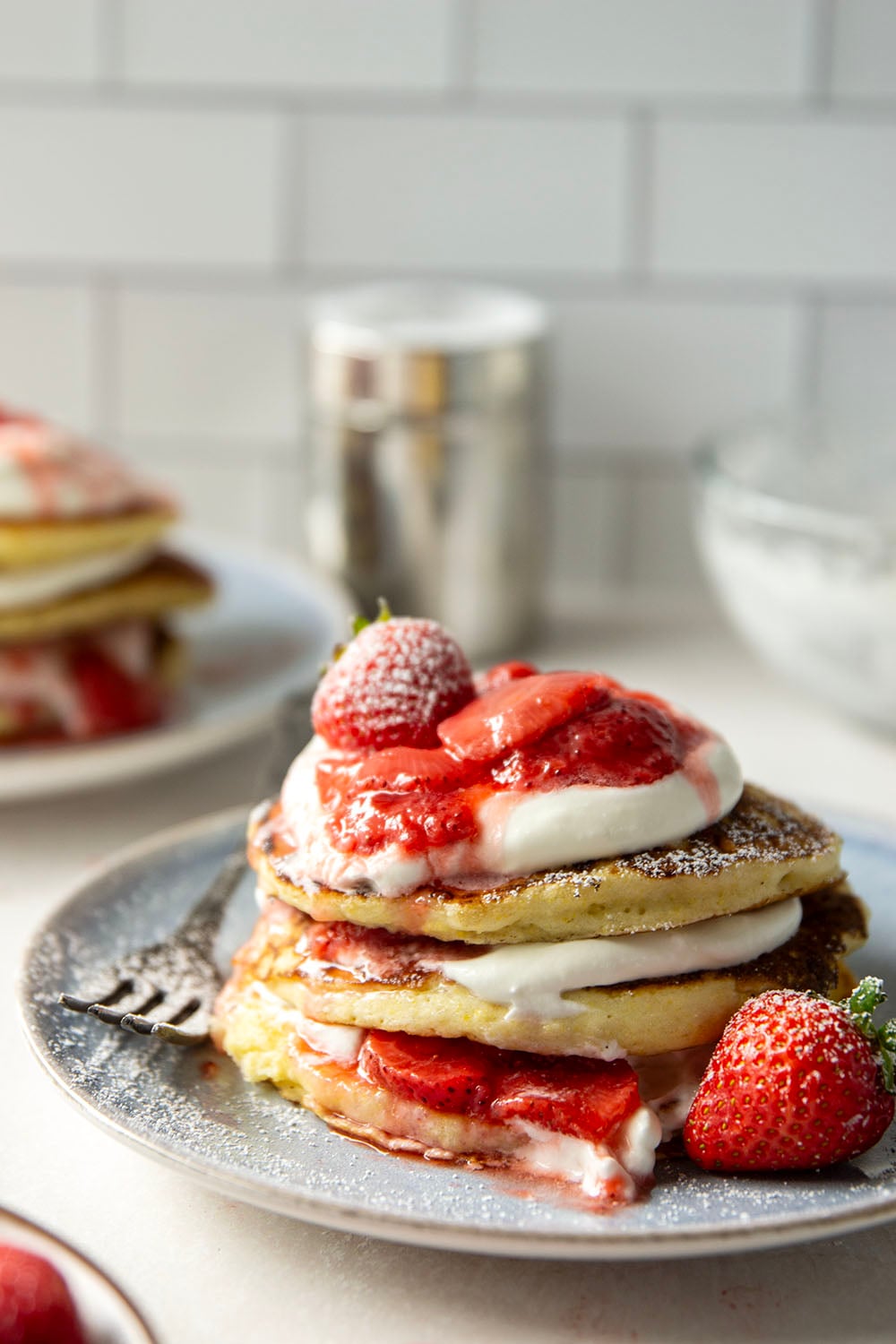 These strawberry shortcake pancakes feature layers of fluffy buttermilk cornmeal pancakes, fresh whipped cream, and lots of juicy fresh strawberry sauce.