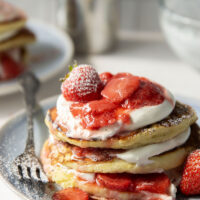 These strawberry shortcake pancakes feature layers of fluffy buttermilk cornmeal pancakes, fresh whipped cream, and lots of juicy fresh strawberry sauce.