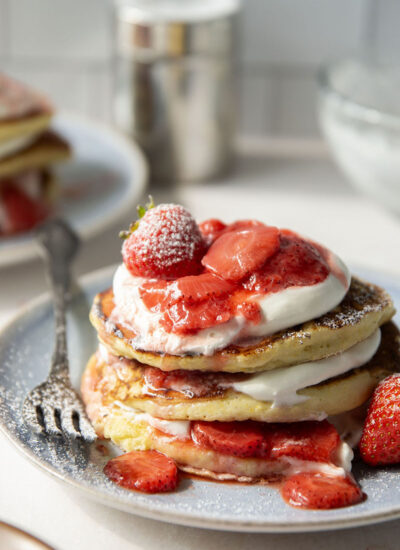 These strawberry shortcake pancakes feature layers of fluffy buttermilk cornmeal pancakes, fresh whipped cream, and lots of juicy fresh strawberry sauce.