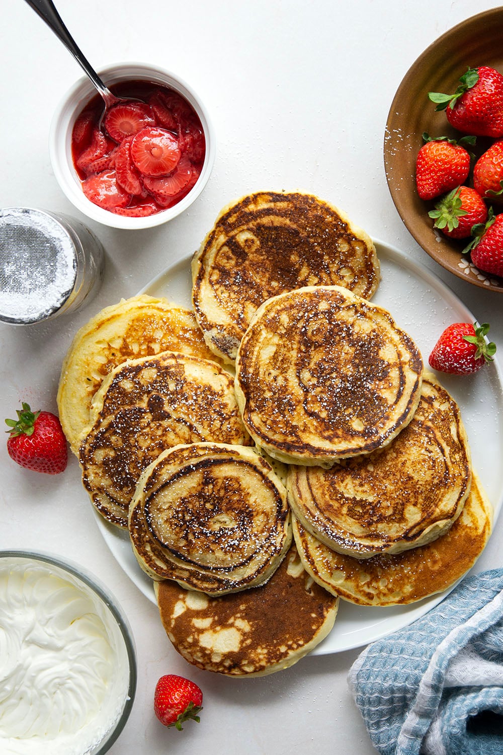These strawberry shortcake pancakes feature layers of fluffy buttermilk cornmeal pancakes, fresh whipped cream, and lots of juicy fresh strawberry sauce.