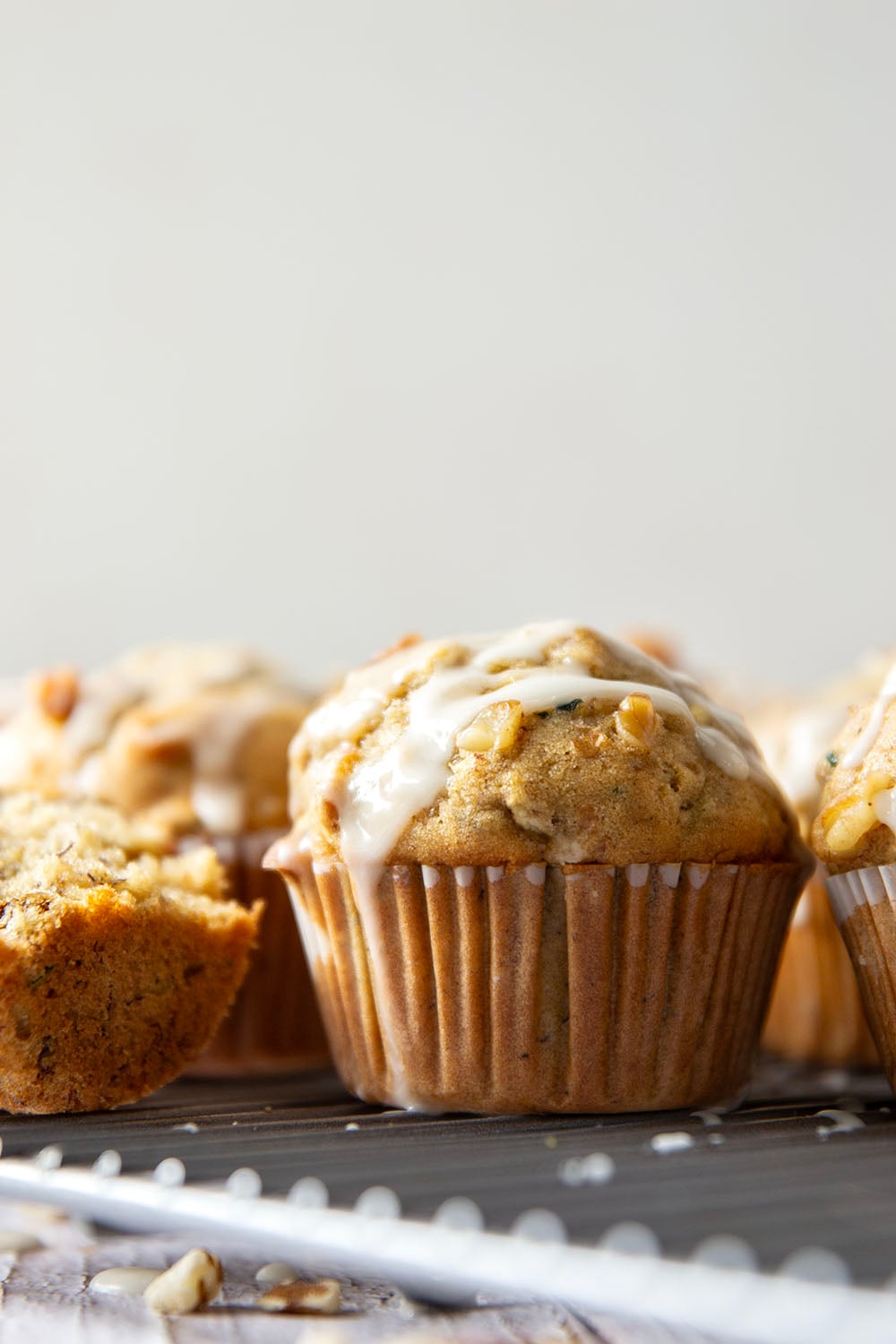 Perfectly spiced and drizzled with a creamy vanilla glaze, these zucchini banana muffins are extra moist from both mashed banana and shredded zucchini.