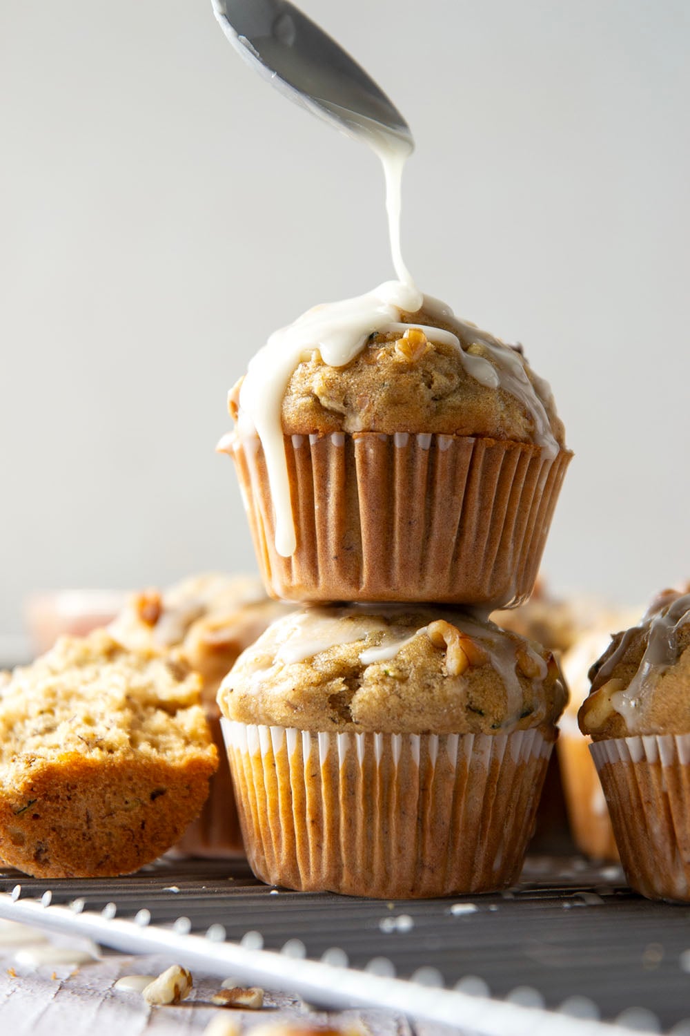 Perfectly spiced and drizzled with a creamy vanilla glaze, these zucchini banana muffins are extra moist from both mashed banana and shredded zucchini.