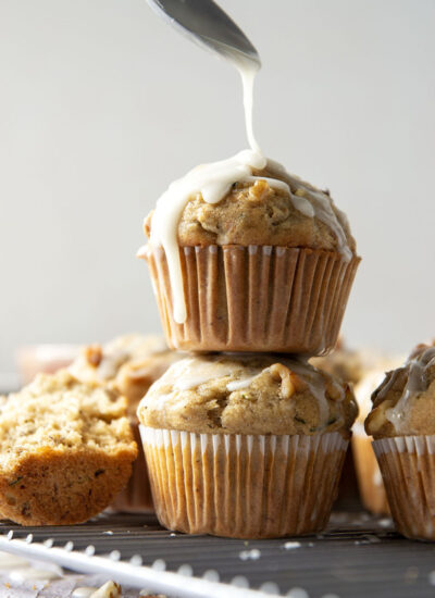 Perfectly spiced and drizzled with a creamy vanilla glaze, these zucchini banana muffins are extra moist from both mashed banana and shredded zucchini.