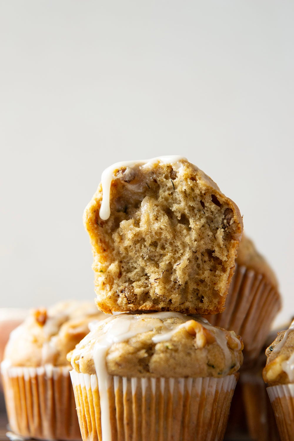 Perfectly spiced and drizzled with a creamy vanilla glaze, these zucchini banana muffins are extra moist from both mashed banana and shredded zucchini.