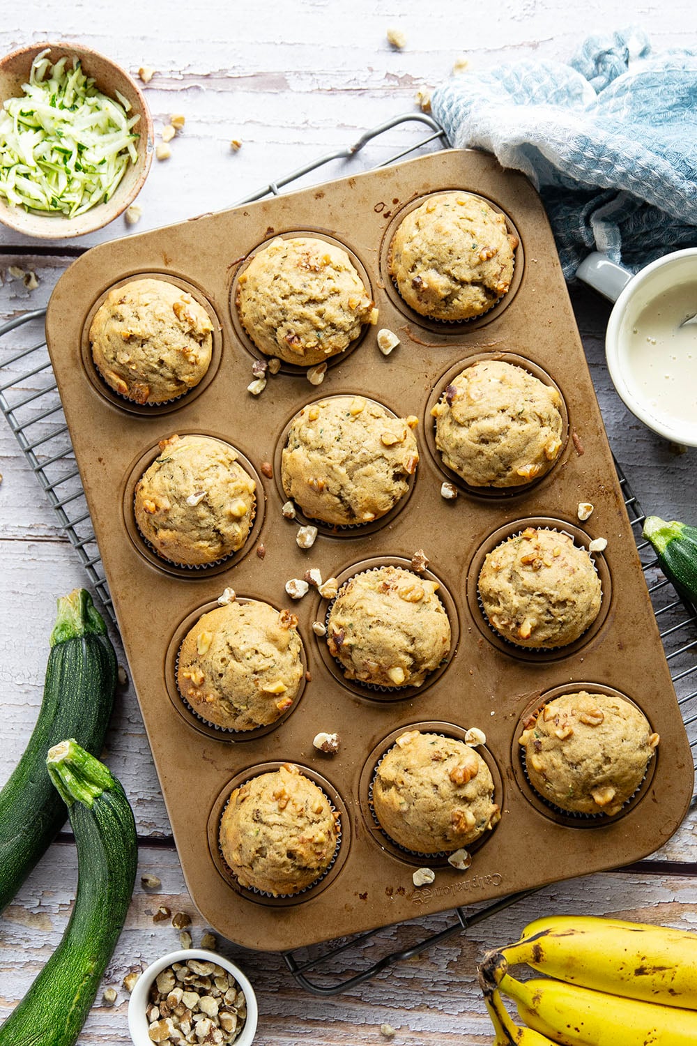 Perfectly spiced and drizzled with a creamy vanilla glaze, these zucchini banana muffins are extra moist from both mashed banana and shredded zucchini.