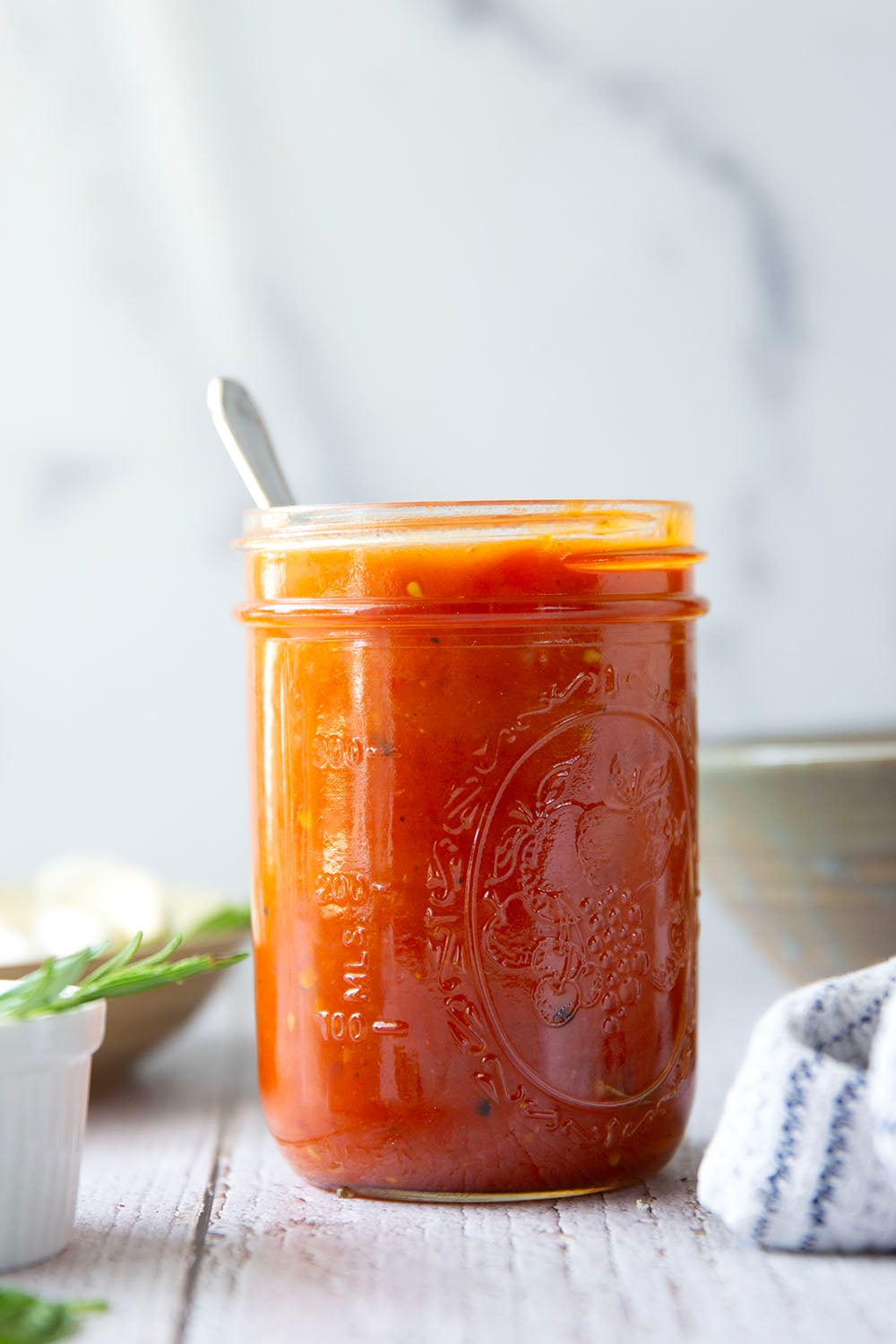 Slow-roasted in plenty of herbs and garlic, this roasted tomato sauce packs the absolute BEST flavors of summer! It's incredible with any kind of pasta and you can also freeze it.