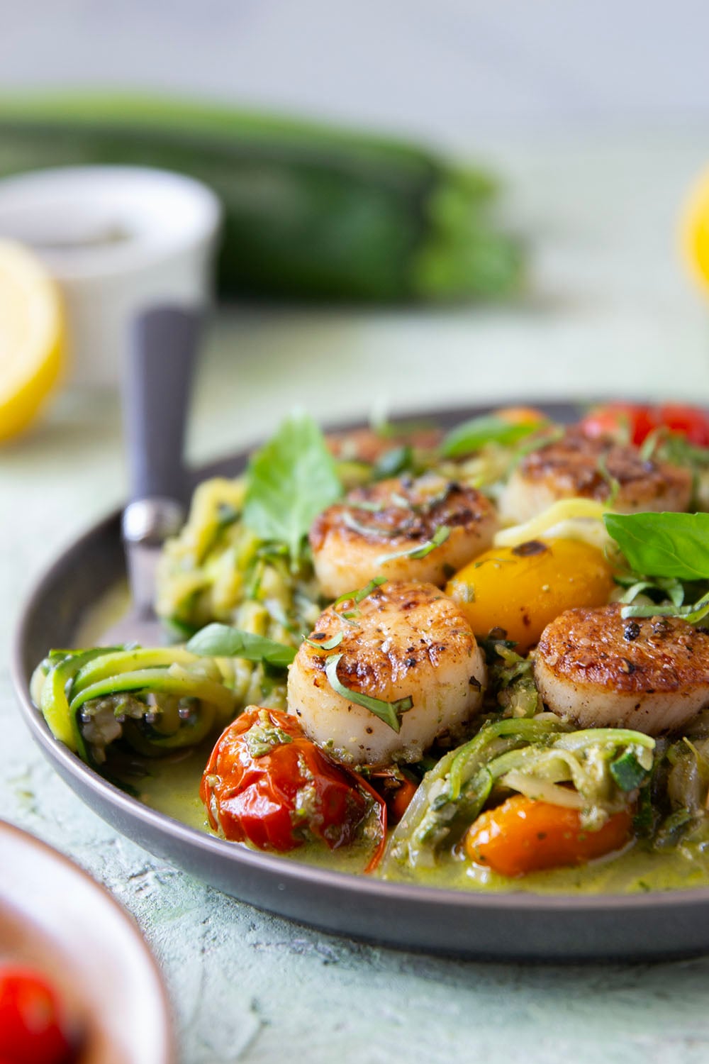 These pesto zucchini noodles come together in minutes with only a handful of summer ingredients and feature lots of flavorful pesto and tender seared scallops on top.