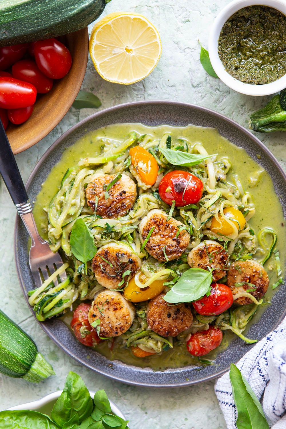 These pesto zucchini noodles come together in minutes with only a handful of summer ingredients and feature lots of flavorful pesto and tender seared scallops on top.