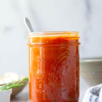 Slow-roasted in plenty of herbs and garlic, this roasted tomato sauce packs the absolute BEST flavors of summer! It's incredible with any kind of pasta and you can also freeze it.