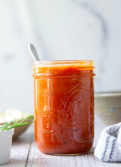 Slow-roasted in plenty of herbs and garlic, this roasted tomato sauce packs the absolute BEST flavors of summer! It's incredible with any kind of pasta and you can also freeze it.