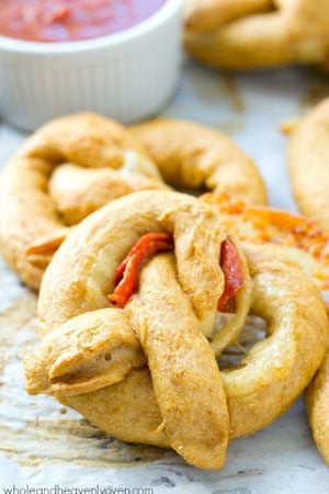 Exploding with gooey cheese and pepperoni slices, these crowd-pleasing soft pretzels are guaranteed to disappear the second you put them out!