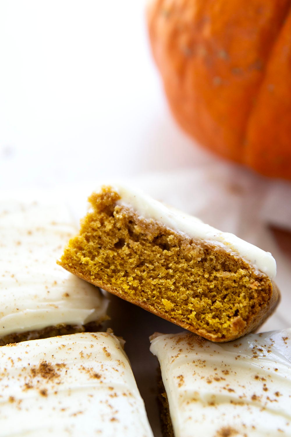 These pumpkin spice bars feature a soft, cake-like texture, lots of pumpkin spice goodness, and a silky cream cheese frosting on top.