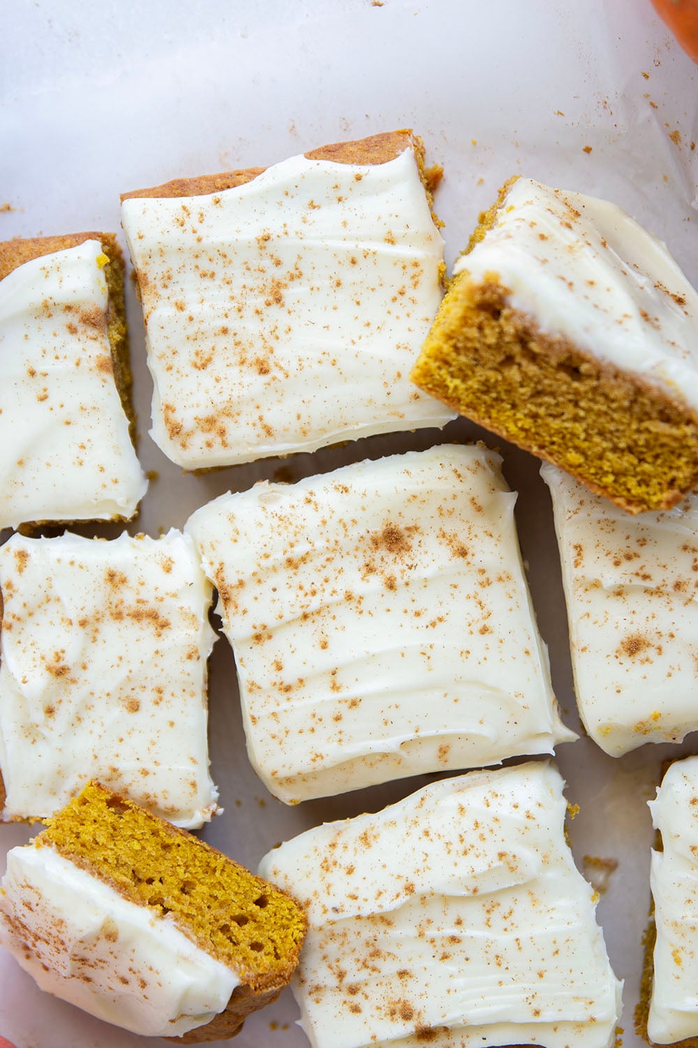 These pumpkin spice bars feature a soft, cake-like texture, lots of pumpkin spice goodness, and a silky cream cheese frosting on top.