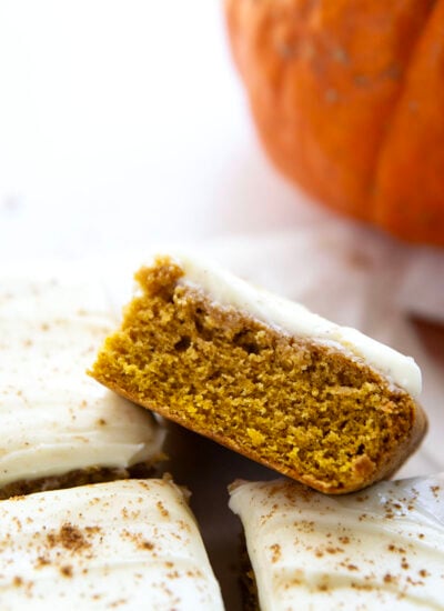 These pumpkin spice bars feature a soft, cake-like texture, lots of pumpkin spice goodness, and a silky cream cheese frosting on top.