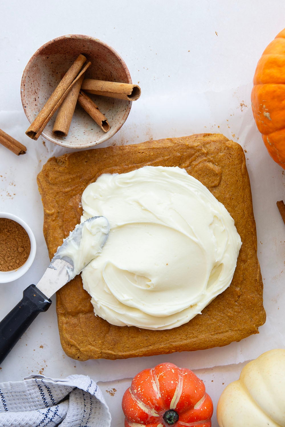 These pumpkin spice bars feature a soft, cake-like texture, lots of pumpkin spice goodness, and a silky cream cheese frosting on top.